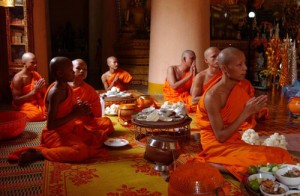 VIENTIANE, LAOS - JULY 24: Buddhist monks pray in thanks for the alms they received to begin Khao Phansa, or the Buddhist's Lent at Wat In Paeng in Vientiane, Laos on July 24, 2002. All monks in the country and in parts of Thailand will remain inside their respective monasteries for three months which coincides with the region's rainy season. It is also the traditional time for many new monks to enter monasteries. (Photo by David Greedy/Getty Images)