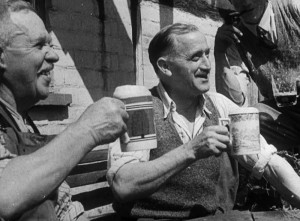 Two men drinking from china pint mugs, from the film Down at the Local, 1945